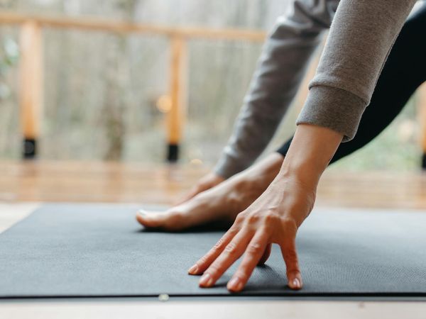 Close-up on hands and feet during a yoga pose, showing focus.